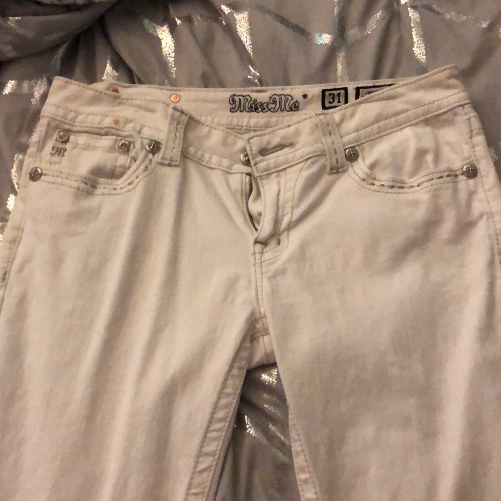 A white pair of Miss Me jeans
